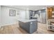 Contemporary kitchen with gray cabinets, stainless steel appliances, and a large island with countertop seating at 1063 W Powers Ave, Littleton, CO 80120