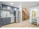 Spacious kitchen with modern appliances, grey cabinets and stylish backsplash leads to the living area at 1063 W Powers Ave, Littleton, CO 80120