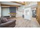 Living area showcases a stone fireplace, exposed wood beams, and open layout to the kitchen at 1063 W Powers Ave, Littleton, CO 80120