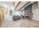 Cozy living area with a stone fireplace, wood beams, and natural light streaming through the window at 1063 W Powers Ave, Littleton, CO 80120