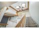 Inviting staircase with skylights and wooden beams creating a bright, open atmosphere at 1063 W Powers Ave, Littleton, CO 80120
