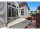 An outdoor living area with a concrete patio, bench, and string lights at 6735 Avrum Dr, Denver, CO 80221