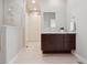 This bathroom features a dark wood vanity, sleek modern fixtures, and a bright, airy design at 6735 Avrum Dr, Denver, CO 80221
