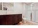 Modern bathroom featuring a vanity with granite countertop and glass-enclosed shower at 6735 Avrum Dr, Denver, CO 80221