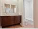 This bathroom features a double vanity, dark wood cabinets, a tub/shower, and neutral walls at 6735 Avrum Dr, Denver, CO 80221