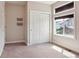A well-lit bedroom with closet and window, featuring carpet floors at 6735 Avrum Dr, Denver, CO 80221