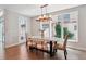 Bright dining room with contemporary lighting fixture, and natural light at 6735 Avrum Dr, Denver, CO 80221