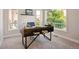 Bright home office with a stylish desk, carpet floors, and a large window at 6735 Avrum Dr, Denver, CO 80221
