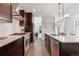 Spacious kitchen featuring stainless steel appliances, ample counter space, and dark wood cabinetry at 6735 Avrum Dr, Denver, CO 80221