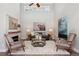 Bright living room featuring vaulted ceilings, a fireplace, and stylish decor at 6735 Avrum Dr, Denver, CO 80221