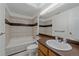 Bathroom with white fixtures, tile accents, and a neutral color scheme offers a clean and functional space at 235 S Monaco Pkwy, Denver, CO 80224