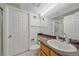 Bright bathroom featuring white fixtures and a granite-look countertop at 235 S Monaco Pkwy, Denver, CO 80224