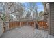 Exterior of deck with wooden railing and view of the backyard at 235 S Monaco Pkwy, Denver, CO 80224