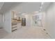 Open concept kitchen featuring an island, stainless steel appliances and carpeted floors at 235 S Monaco Pkwy, Denver, CO 80224