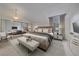 Serene main bedroom featuring a large bed, mirrored closet, and stylish nightstands with lamps at 235 S Monaco Pkwy, Denver, CO 80224