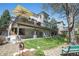 Expansive backyard features a patio, upper deck, and lush lawn at 3002 S Oak Way, Lakewood, CO 80227