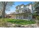 Exterior of home featuring a backyard with a patio and deck perfect for entertaining at 3002 S Oak Way, Lakewood, CO 80227