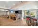 Open basement area with custom bar, island seating, and entertainment space at 3002 S Oak Way, Lakewood, CO 80227