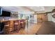 Finished basement with a custom bar, wood countertop, rustic stools, and a sliding barn door at 3002 S Oak Way, Lakewood, CO 80227