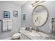 Stylish bathroom featuring vanity with marble countertop, framed mirror, and shower with glass door at 3002 S Oak Way, Lakewood, CO 80227