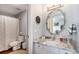 Bathroom featuring vanity with granite countertop, decorative mirror and a shower/tub at 3002 S Oak Way, Lakewood, CO 80227