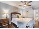 Cozy bedroom with decorative pillows and bedding, side tables with lamps, and ceiling fan at 3002 S Oak Way, Lakewood, CO 80227