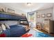 Cozy bedroom with a bunkbed, plush decor, and natural light coming through the window at 3002 S Oak Way, Lakewood, CO 80227