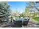 Enjoy outdoor dining on the deck with comfortable seating and serene views of the surrounding landscape at 3002 S Oak Way, Lakewood, CO 80227
