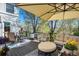 Outdoor living space on the deck includes comfortable seating, a grill, and a large umbrella at 3002 S Oak Way, Lakewood, CO 80227