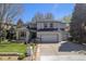 Beautiful two-story home boasting a manicured lawn, rock garden, and a spacious two-car garage at 3002 S Oak Way, Lakewood, CO 80227