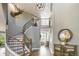 Grand foyer with a curved staircase, hardwood floors, and elegant decor at 3002 S Oak Way, Lakewood, CO 80227