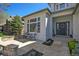 Charming front yard featuring a stone patio, manicured landscaping, and a welcoming entrance at 3002 S Oak Way, Lakewood, CO 80227