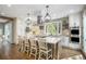 Bright kitchen features a large island with seating, stainless steel appliances, and a large window at 3002 S Oak Way, Lakewood, CO 80227