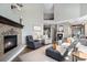 Inviting living room featuring a stone fireplace, comfortable seating, and an open layout at 3002 S Oak Way, Lakewood, CO 80227