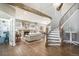 Spacious open-concept living room featuring hardwood floors, a fireplace, and ample natural light at 3002 S Oak Way, Lakewood, CO 80227