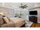 Bright main bedroom featuring a sitting area, hardwood floors, and a ceiling fan at 3002 S Oak Way, Lakewood, CO 80227