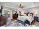 Comfortable bedroom with a tray ceiling, ceiling fan, and ample natural light at 3002 S Oak Way, Lakewood, CO 80227