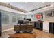 Spacious office featuring a large desk, natural light, sports memorabilia, and wood-look flooring at 3002 S Oak Way, Lakewood, CO 80227