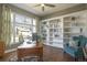 Cozy home office with custom built-in shelves, hardwood floors, and a large window at 3002 S Oak Way, Lakewood, CO 80227