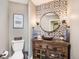 Chic powder room with unique vessel sink, decorative mirror, and custom-designed tile accent wall at 3002 S Oak Way, Lakewood, CO 80227