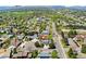 Aerial shot of home nestled in a friendly neighborhood with mature trees and green spaces at 411 S Cody Ct, Lakewood, CO 80226