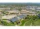 An aerial view showcasing nearby shopping centers, commercial buildings, and green spaces at 411 S Cody Ct, Lakewood, CO 80226