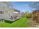 Landscaped backyard with a lawn, shed, covered patio and dining table at 411 S Cody Ct, Lakewood, CO 80226