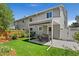Relaxing backyard setting with a covered patio and well-maintained lawn at 411 S Cody Ct, Lakewood, CO 80226