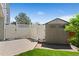 Cozy backyard features a small storage shed and white privacy fence at 411 S Cody Ct, Lakewood, CO 80226