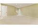 Spacious basement with carpet flooring, a staircase, and a door at 411 S Cody Ct, Lakewood, CO 80226