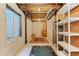 Exposed basement with concrete walls, storage shelving, and a window at 411 S Cody Ct, Lakewood, CO 80226