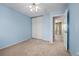Bedroom with blue walls, closet, and view into a hallway at 411 S Cody Ct, Lakewood, CO 80226
