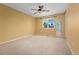 A spacious bedroom with a ceiling fan and a window with outside views at 411 S Cody Ct, Lakewood, CO 80226