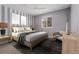 Cozy bedroom featuring striped accent wall and natural light at 411 S Cody Ct, Lakewood, CO 80226